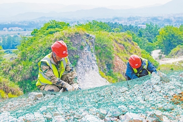 5月17日， 武穴市田镇马口采石厂修复现场，中南电力设计院有限公司工作人员在山脚下定检自动化喷淋系统。